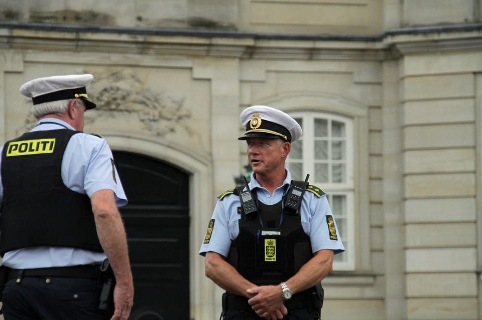 Two Danish police officers talking outside Amalienborg Palace in Copenhagen